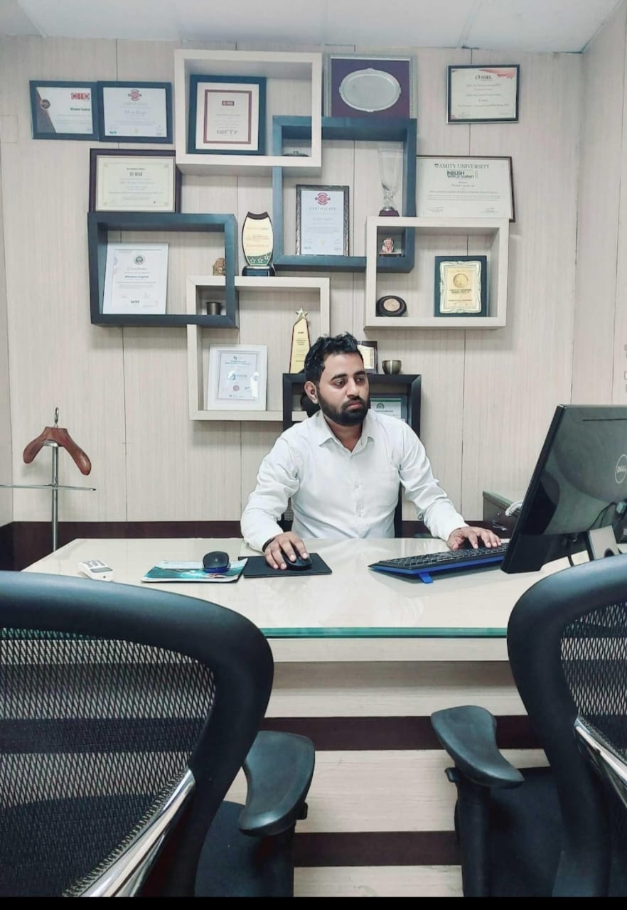 Pulkit Sharma at his desk with professional credentials, 2021